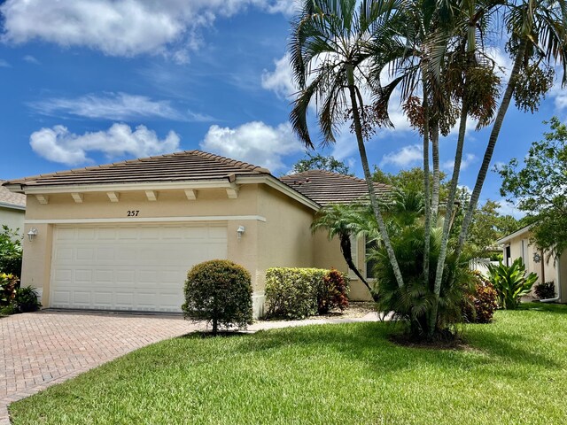 view of front of home with a garage and a front yard