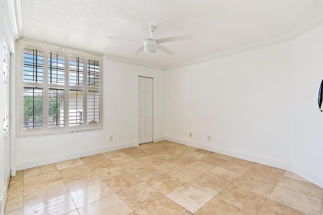 tiled empty room with crown molding, ceiling fan, and a textured ceiling