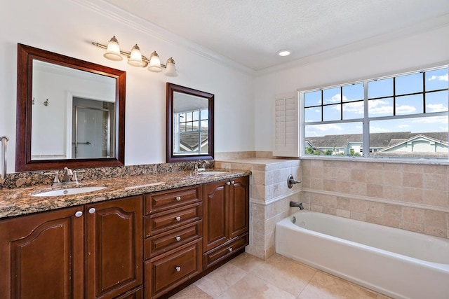 bathroom featuring a tub, tile walls, tile patterned flooring, vanity, and a textured ceiling