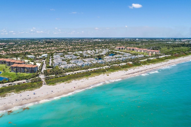 bird's eye view with a water view and a beach view