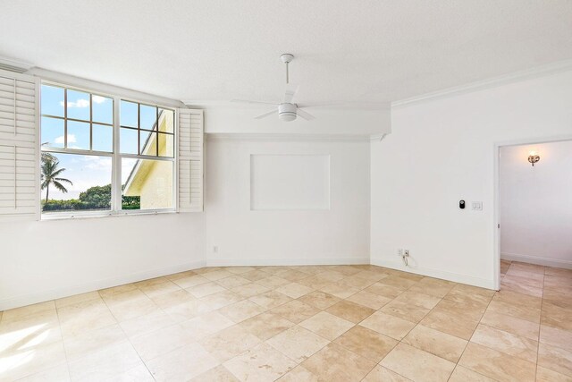 tiled spare room featuring ornamental molding, a textured ceiling, and ceiling fan