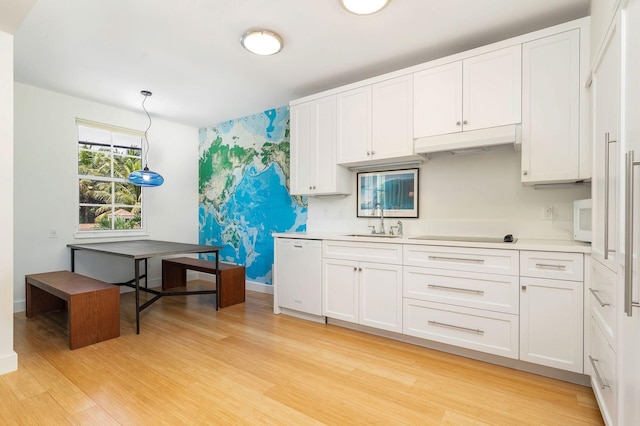 kitchen with white cabinetry, light hardwood / wood-style floors, and sink