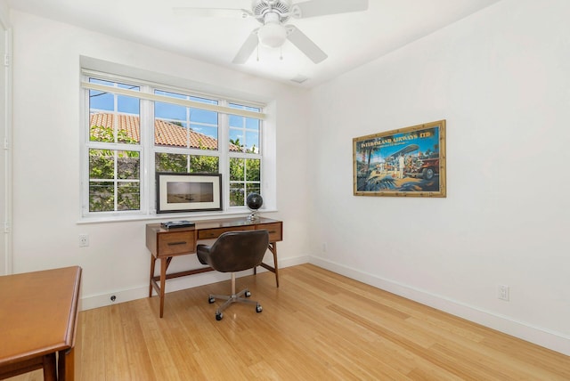 office featuring ceiling fan, baseboards, and wood finished floors