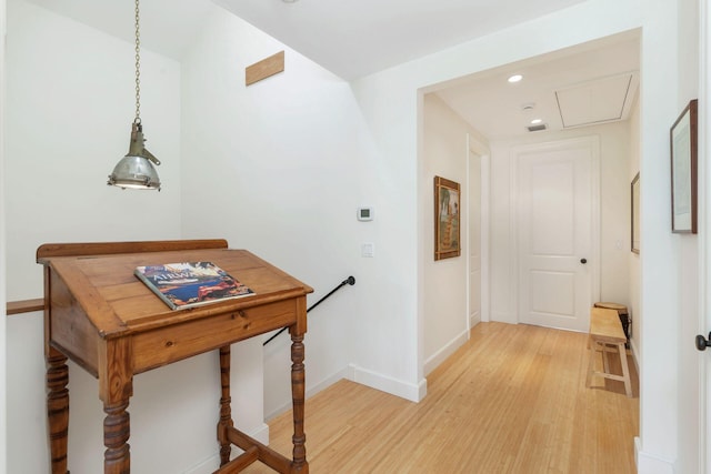 hallway with light wood-style floors, recessed lighting, baseboards, and an upstairs landing