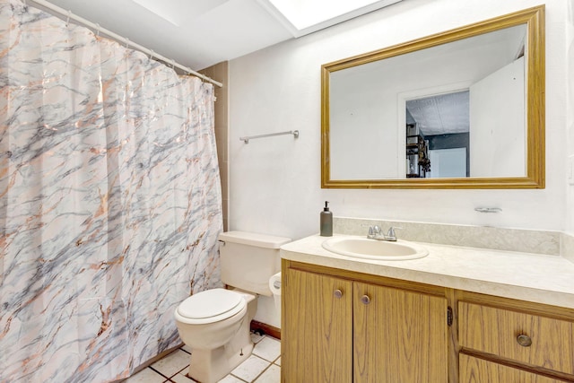 bathroom featuring toilet, vanity, and tile patterned flooring