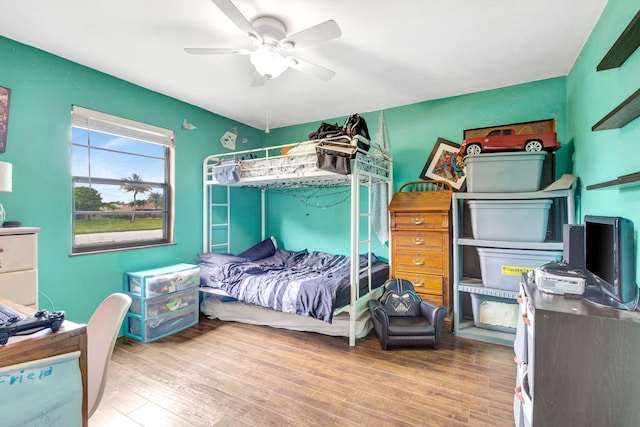 bedroom with ceiling fan and wood-type flooring