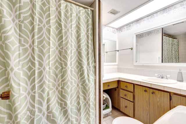 bathroom with tile patterned floors, vanity, and a shower with curtain