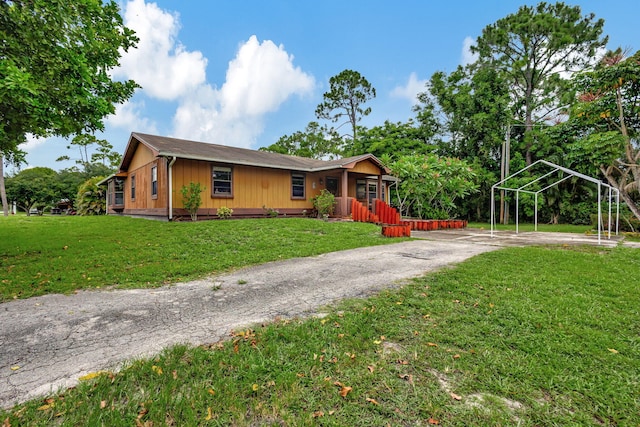 ranch-style home with a front yard and a porch