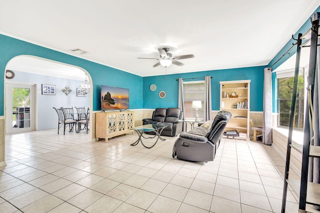 living room featuring ceiling fan with notable chandelier, a wealth of natural light, and light tile patterned floors