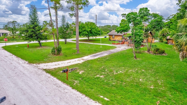 view of home's community with a yard