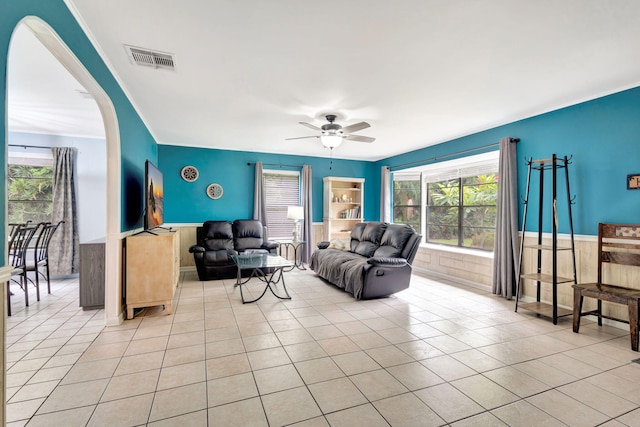 tiled living room with ceiling fan and a wealth of natural light