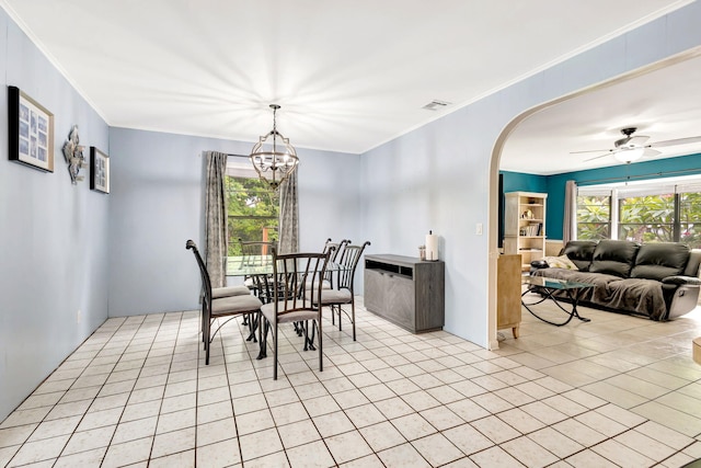 tiled dining room with crown molding and ceiling fan with notable chandelier