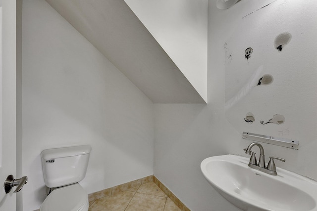 bathroom featuring toilet, sink, and tile patterned floors