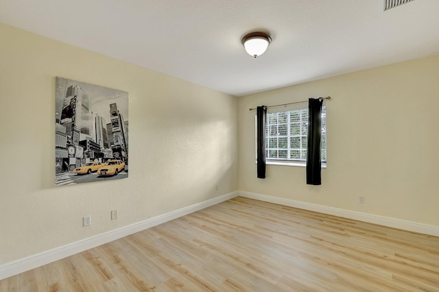 unfurnished room with hardwood / wood-style floors