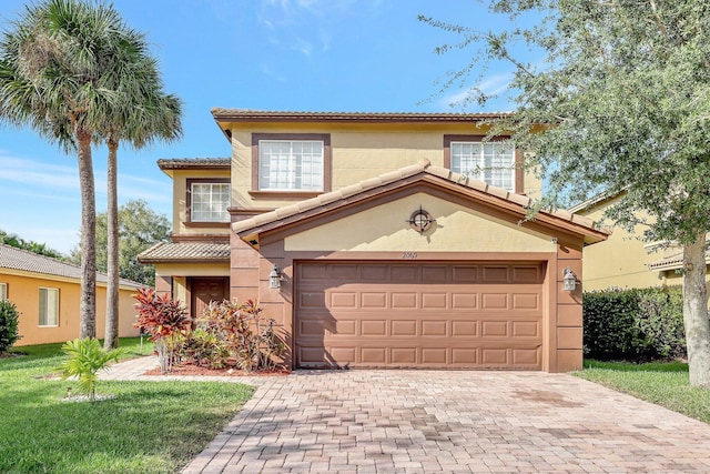 mediterranean / spanish-style house with a garage and a front lawn