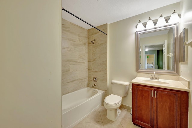 full bathroom featuring tile patterned flooring, a textured ceiling, vanity, tiled shower / bath, and toilet