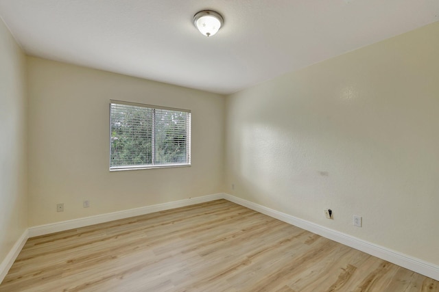 spare room featuring light hardwood / wood-style flooring