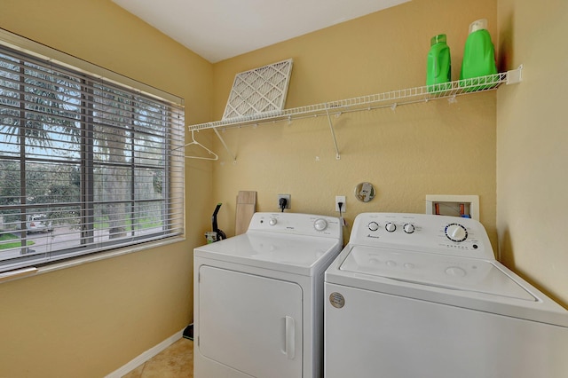 washroom with light tile patterned floors and washer and dryer