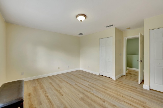 unfurnished bedroom with light wood-type flooring