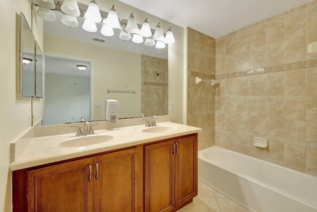 bathroom with vanity, tiled shower / bath combo, and tile patterned floors