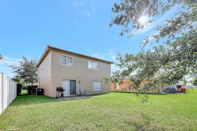 back of property featuring a lawn and a patio area