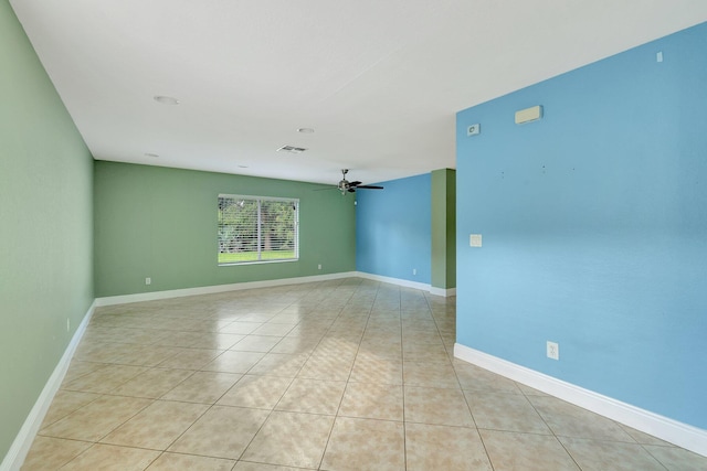 empty room featuring ceiling fan and light tile patterned flooring