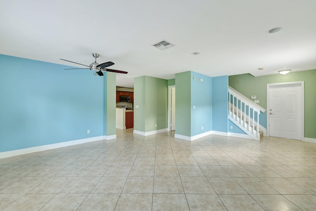 unfurnished living room with ceiling fan and light tile patterned flooring