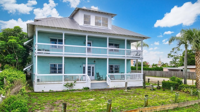 back of property with a balcony and a porch