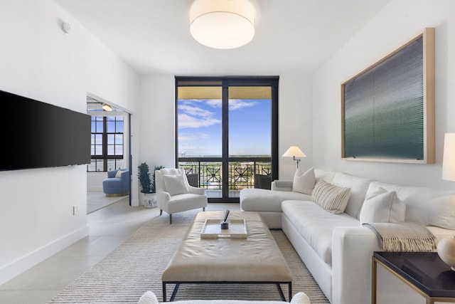 living room with tile patterned flooring and floor to ceiling windows