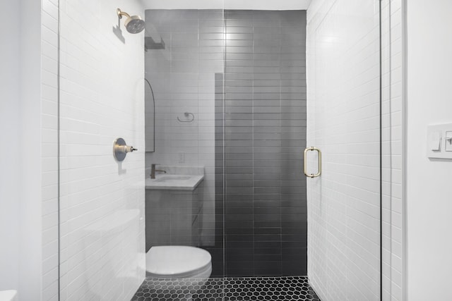 bathroom with toilet, tile patterned floors, and walk in shower