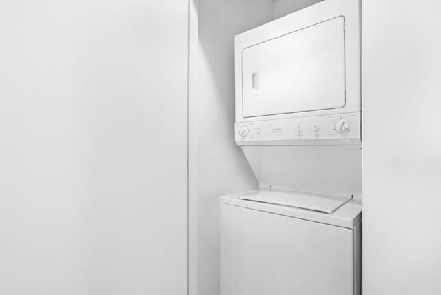 laundry area with stacked washer / dryer