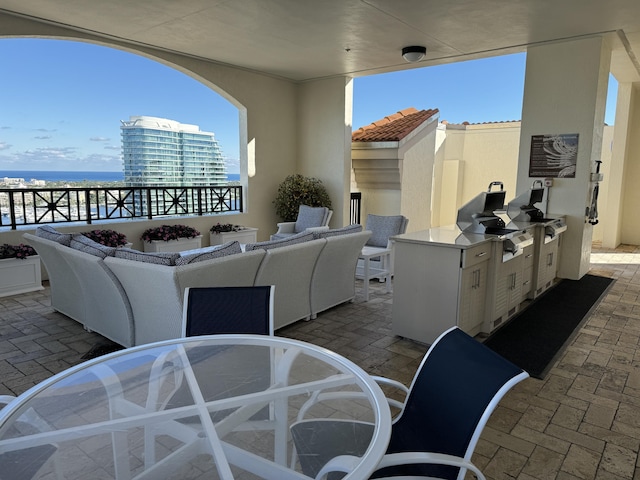 view of patio featuring a water view, area for grilling, and outdoor lounge area