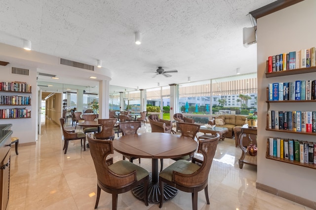 dining room featuring a textured ceiling, ceiling fan, light tile patterned floors, and a wealth of natural light