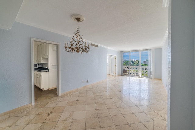 spare room with light tile patterned floors, ornamental molding, an inviting chandelier, and a wall of windows