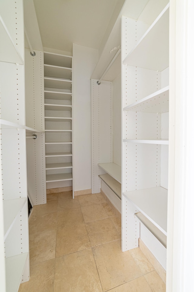 walk in closet with tile patterned floors