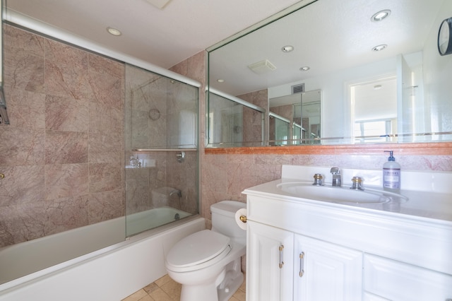 full bathroom with vanity, toilet, tile patterned floors, and enclosed tub / shower combo