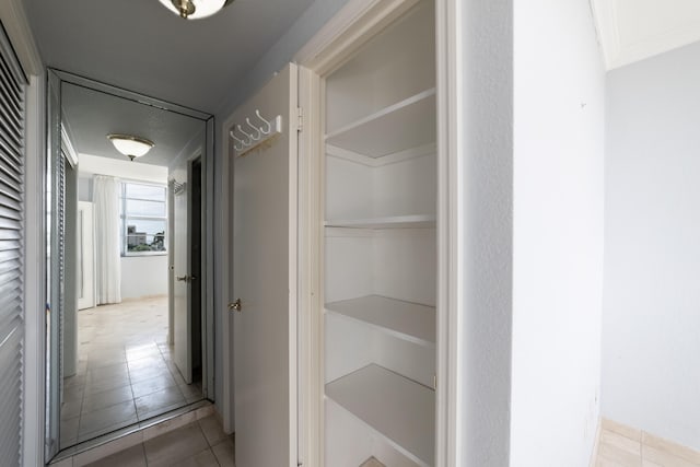 hall with tile patterned flooring