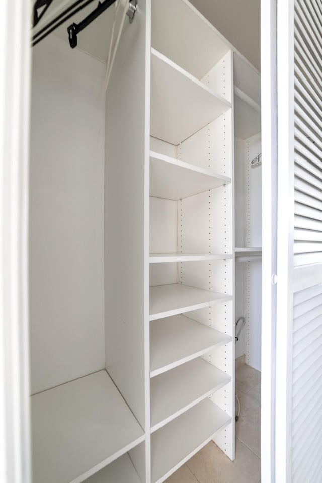 spacious closet featuring light tile patterned flooring