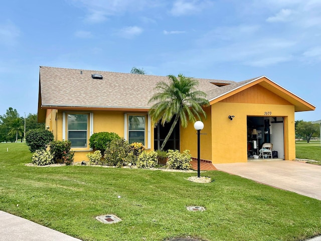 view of front of house featuring a garage and a front lawn