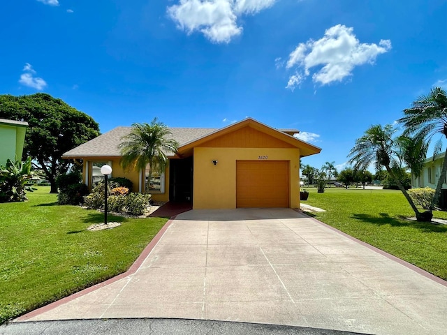 single story home featuring a garage and a front lawn