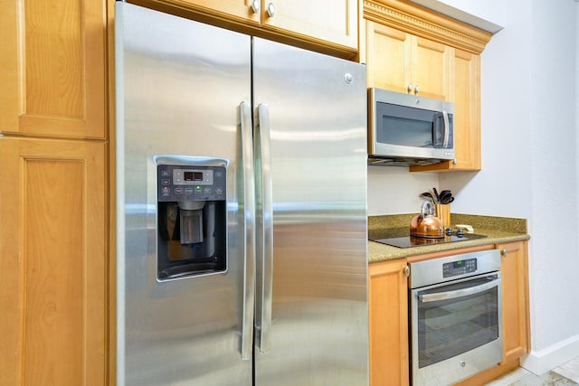 kitchen with light brown cabinetry, appliances with stainless steel finishes, light tile patterned flooring, and light stone counters