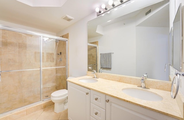 bathroom with a shower with shower door, tile patterned floors, toilet, and dual bowl vanity