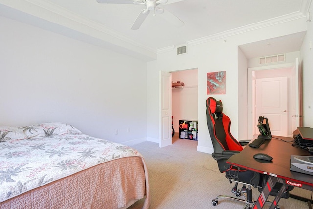 carpeted bedroom featuring a closet, ceiling fan, a spacious closet, and crown molding