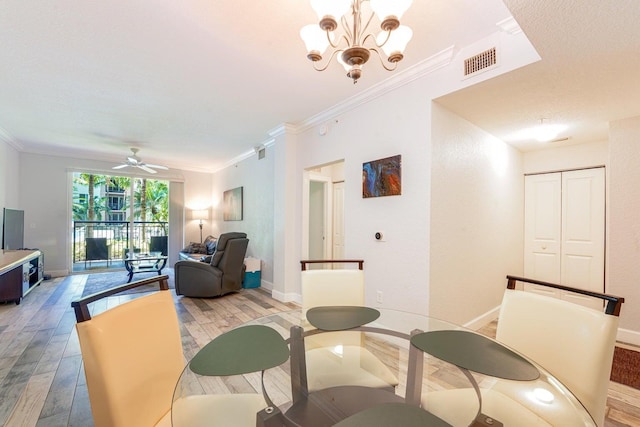 dining space featuring ornamental molding, ceiling fan with notable chandelier, and hardwood / wood-style flooring