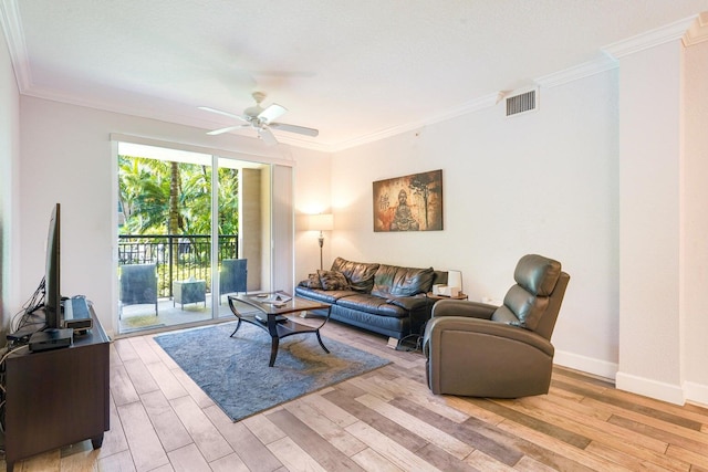 living room featuring ceiling fan, crown molding, and hardwood / wood-style flooring