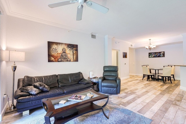 living room featuring ornamental molding, ceiling fan with notable chandelier, and light wood-type flooring