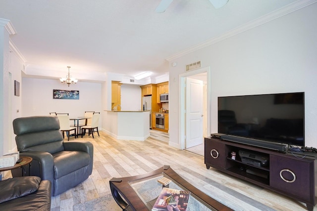 living room with ornamental molding, light hardwood / wood-style flooring, and ceiling fan with notable chandelier