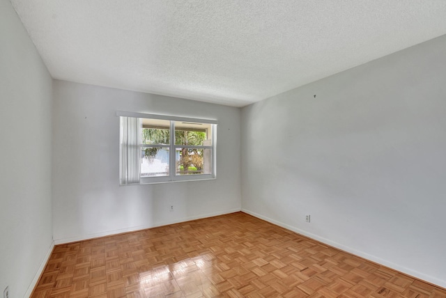 unfurnished room featuring a textured ceiling and light parquet floors