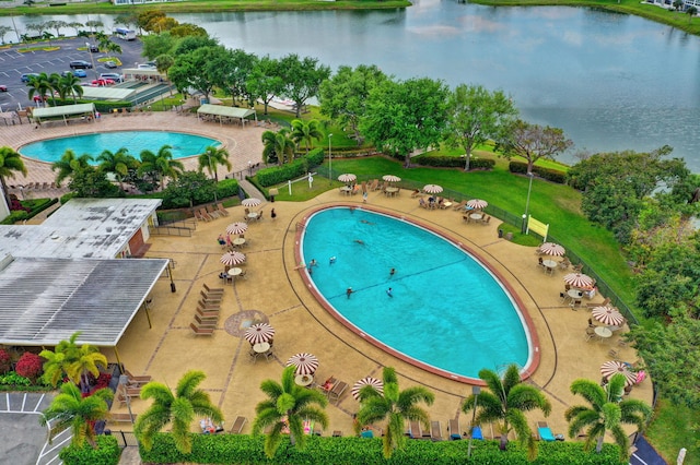 view of pool featuring a patio and a water view