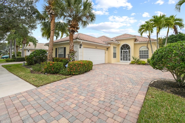 mediterranean / spanish-style house with a garage